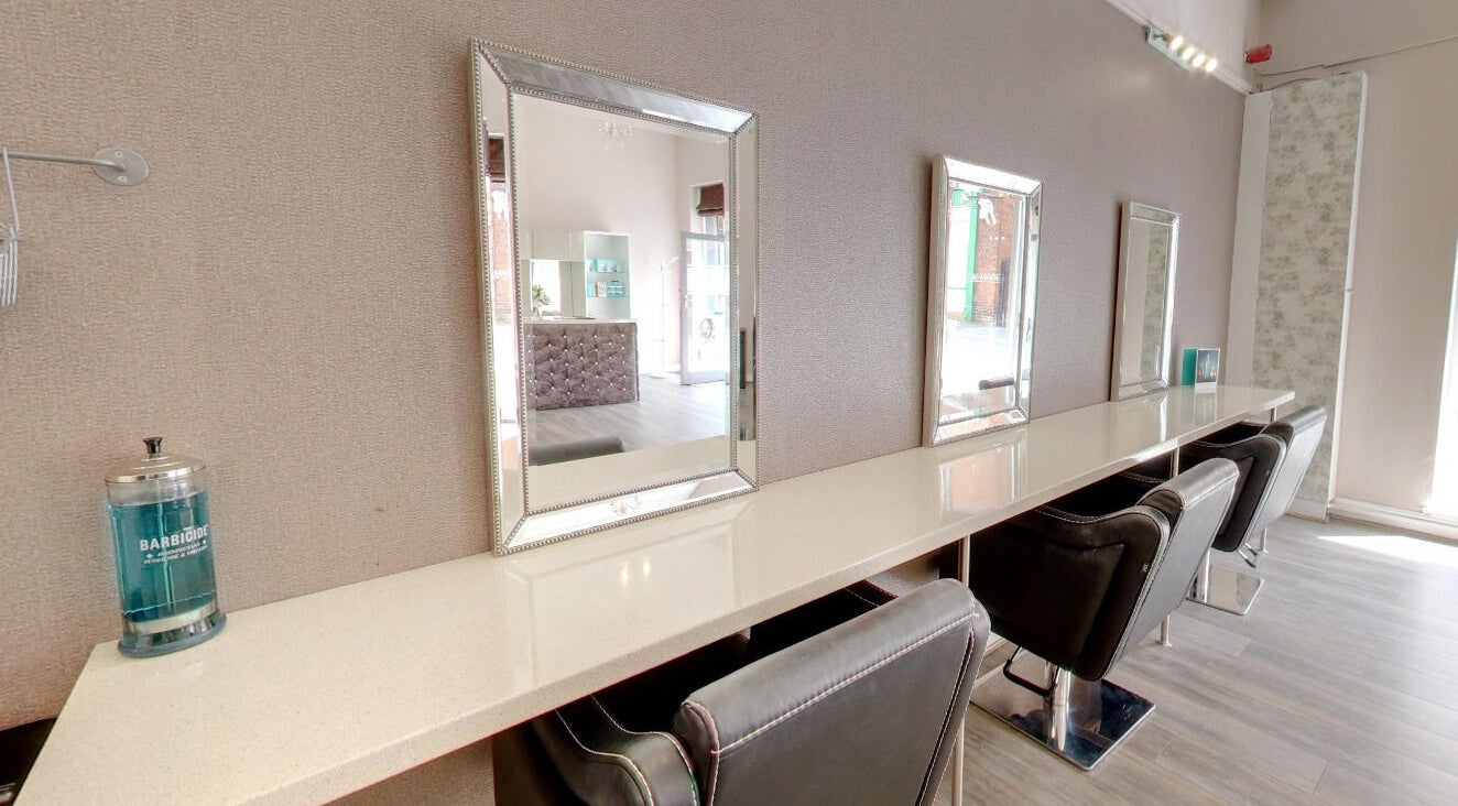 Chic styling area at Laura at Tailor Made Hair Extensions in Sedgley, England, GB with modern mirrors and chairs.
