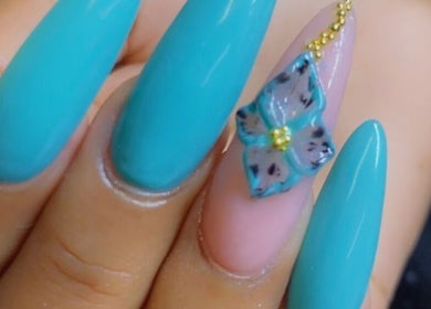 Elegant blue nail art with floral accent at Alluring Nails by Tammy, New Providence, BS.