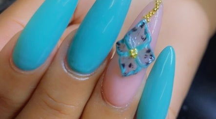 Elegant blue nail art with floral accent at Alluring Nails by Tammy, New Providence, BS.