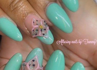 Floral design on aqua nails at Alluring Nails by Tammy, New Providence, BS.