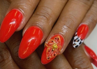 Exquisite red nails with floral art at Alluring Nails by Tammy, New Providence, BS.