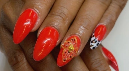Exquisite red nails with floral art at Alluring Nails by Tammy, New Providence, BS.