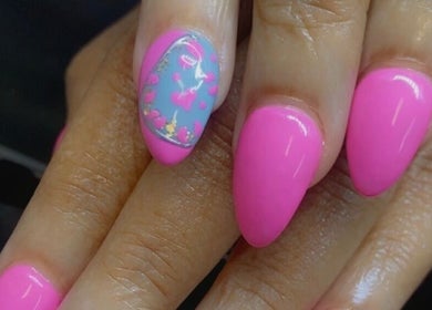 Bright pink nails with floral design at Alluring Nails by Tammy, New Providence, BS.
