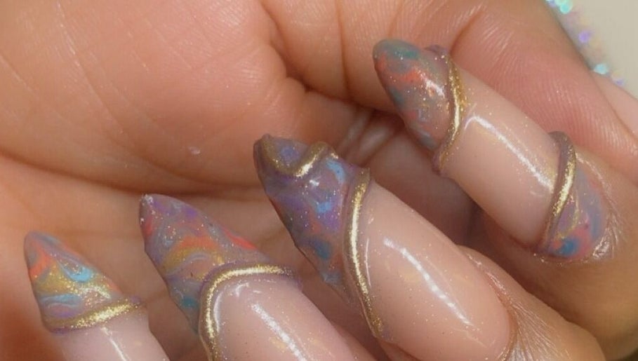 Stunning cosmic nail art at Alluring Nails by Tammy, New Providence, BS, showcasing vibrant colors and elegant design.