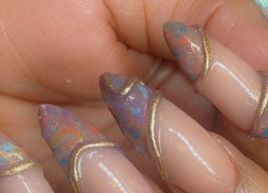 Stunning cosmic nail art at Alluring Nails by Tammy, New Providence, BS, showcasing vibrant colors and elegant design.
