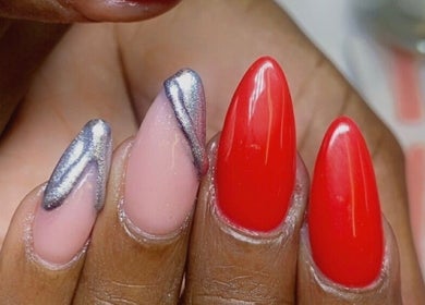 Elegant red and metallic nail art at Alluring Nails by Tammy, New Providence, BS.