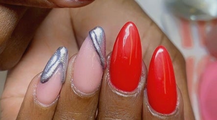 Elegant red and metallic nail art at Alluring Nails by Tammy, New Providence, BS.
