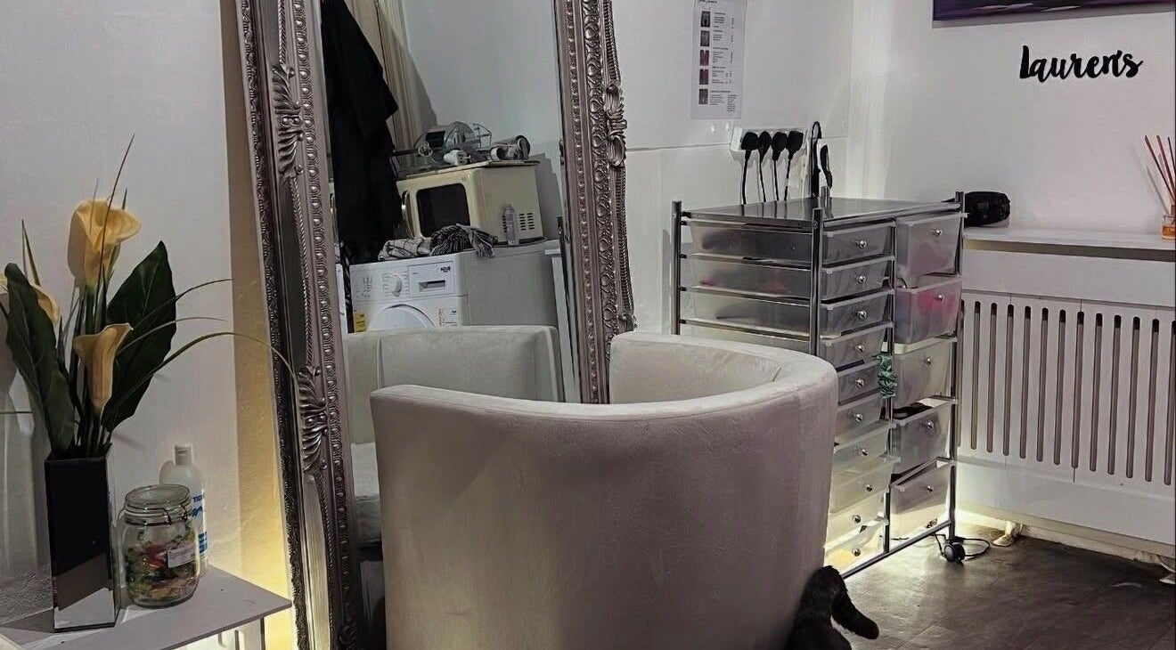 Luxurious salon interior at Hair by Lauren Lawrence, Falmouth, England, GB featuring ornate mirror and plush chair.
