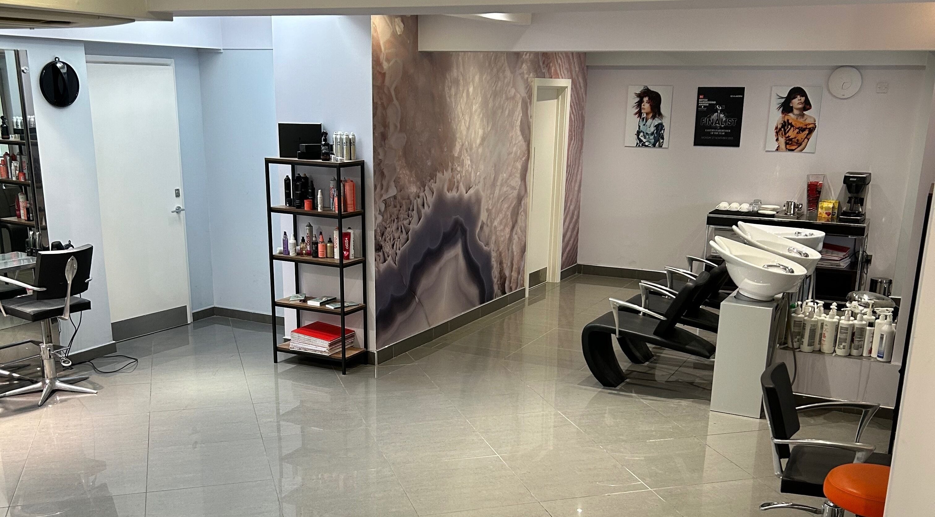 Modern interior of Antonio Giovanni Hairdressing Friars Street, Ipswich, England, GB with sleek chairs and products.