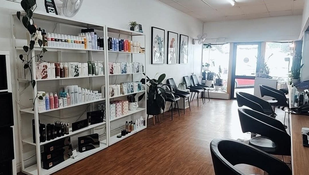 Interior of Lincoln Hair Shack in Port Lincoln, South Australia, AU, featuring sleek styling chairs and product shelves.