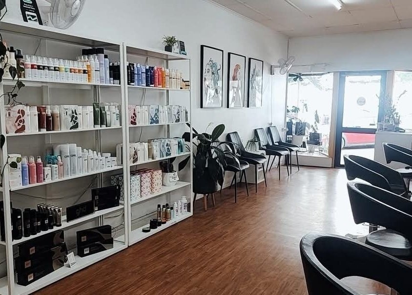 Interior of Lincoln Hair Shack in Port Lincoln, South Australia, AU, featuring sleek styling chairs and product shelves.