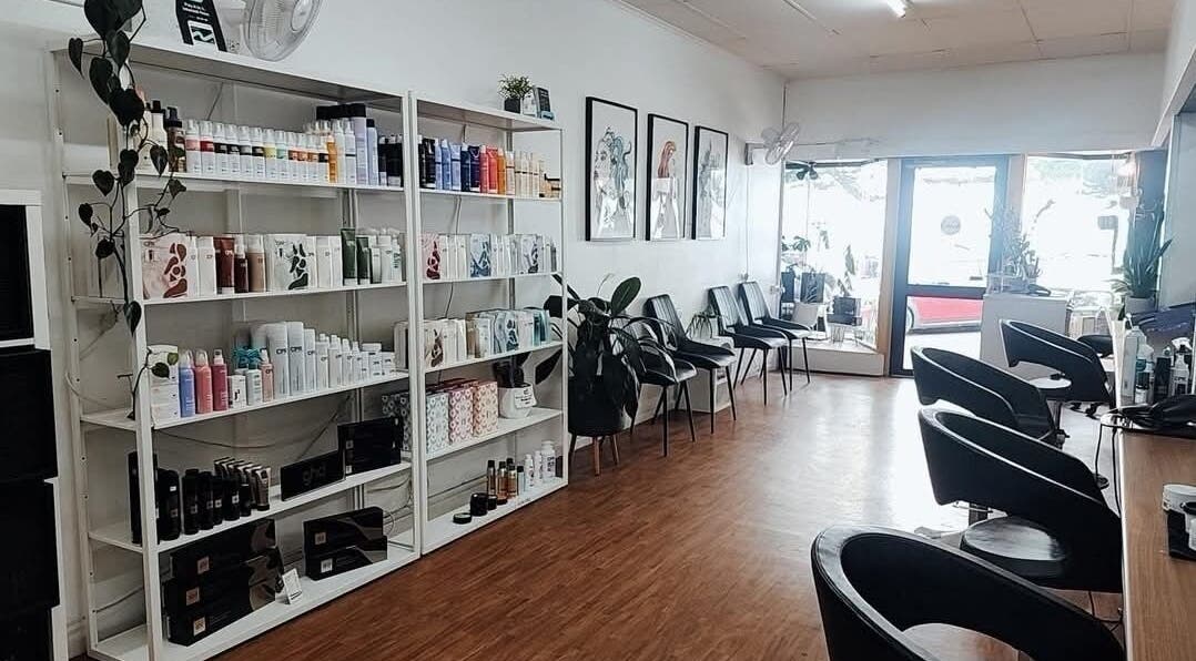 Interior of Lincoln Hair Shack in Port Lincoln, South Australia, AU, featuring sleek styling chairs and product shelves.