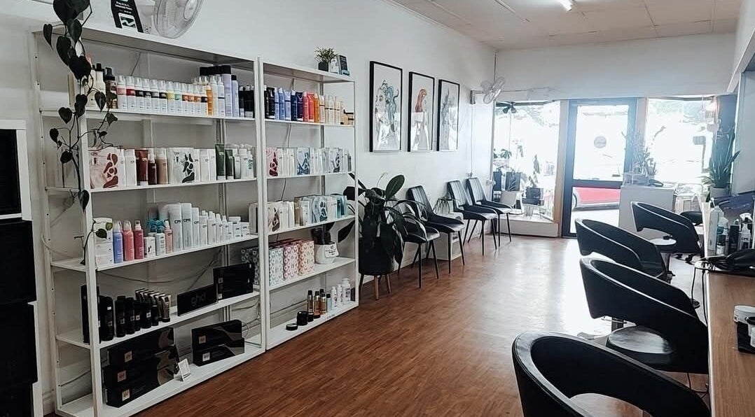 Interior of Lincoln Hair Shack in Port Lincoln, South Australia, AU, featuring sleek styling chairs and product shelves.
