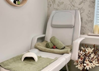 Relaxing nail salon chair at Kate Matthews Master Nail Artist, Weymouth, England, GB with flowers and candles.