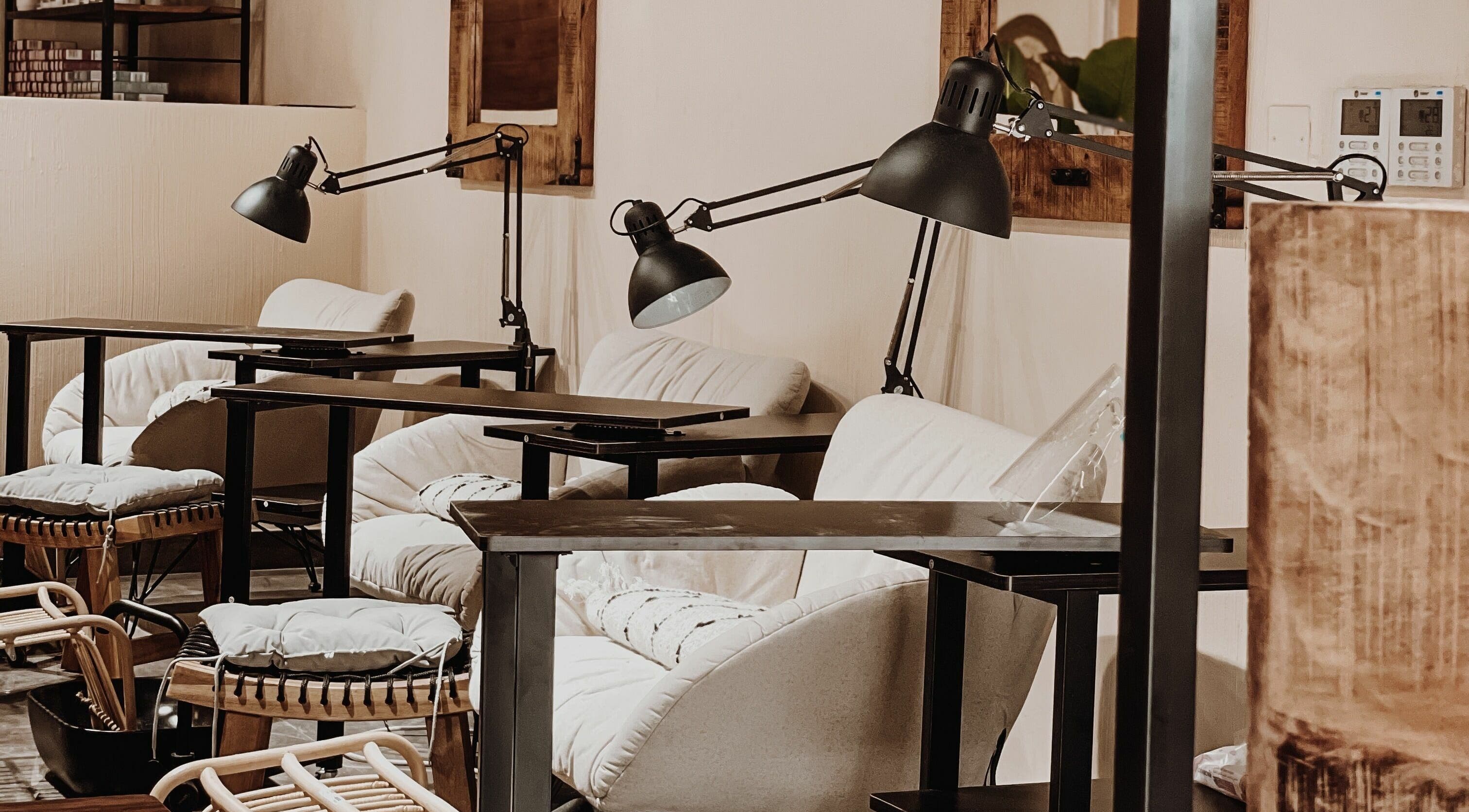 Stylish manicure setup at Tag Ladies Beauty Salon in Dubai, AE with plush chairs and sleek lamps.