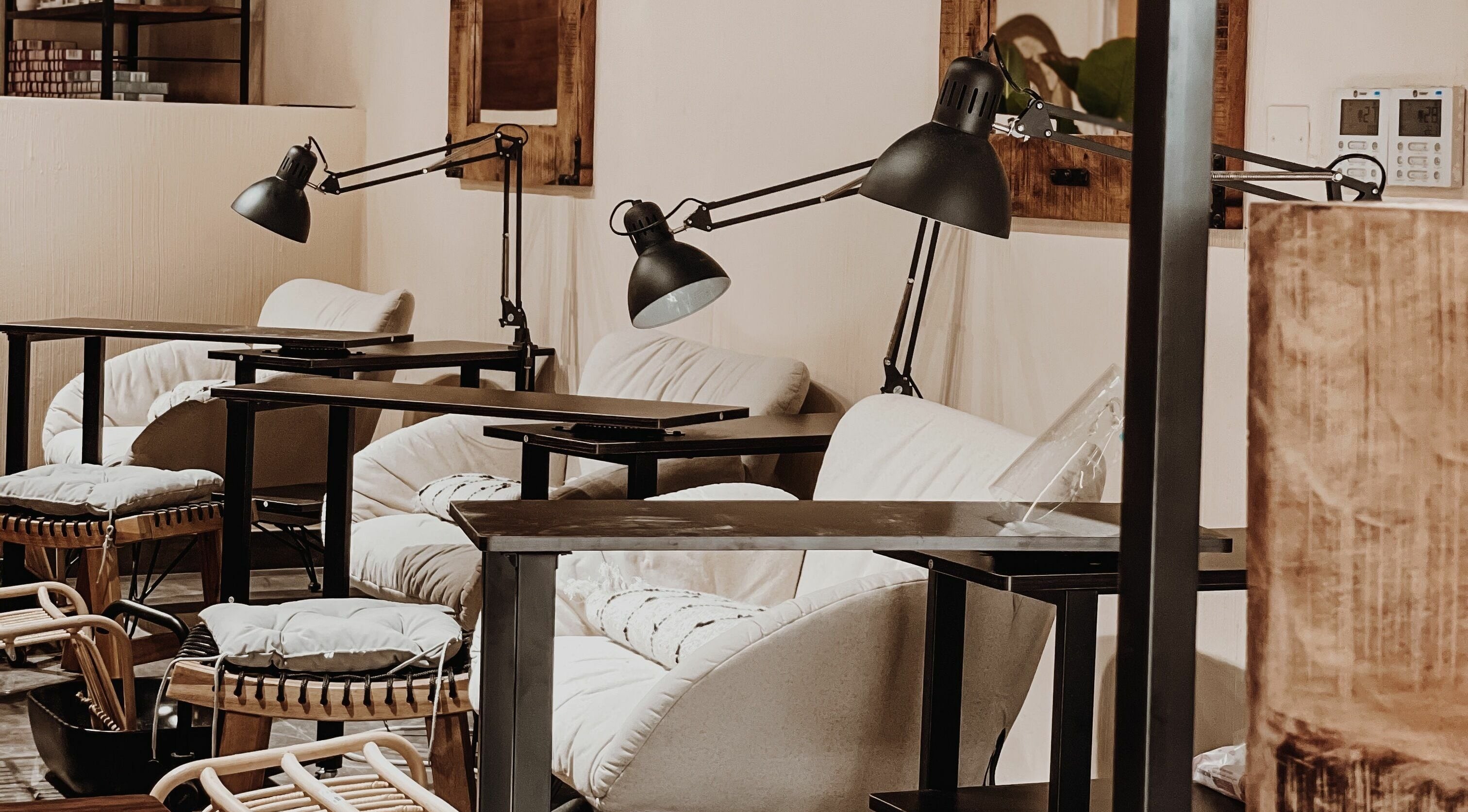 Stylish manicure setup at Tag Ladies Beauty Salon in Dubai, AE with plush chairs and sleek lamps.