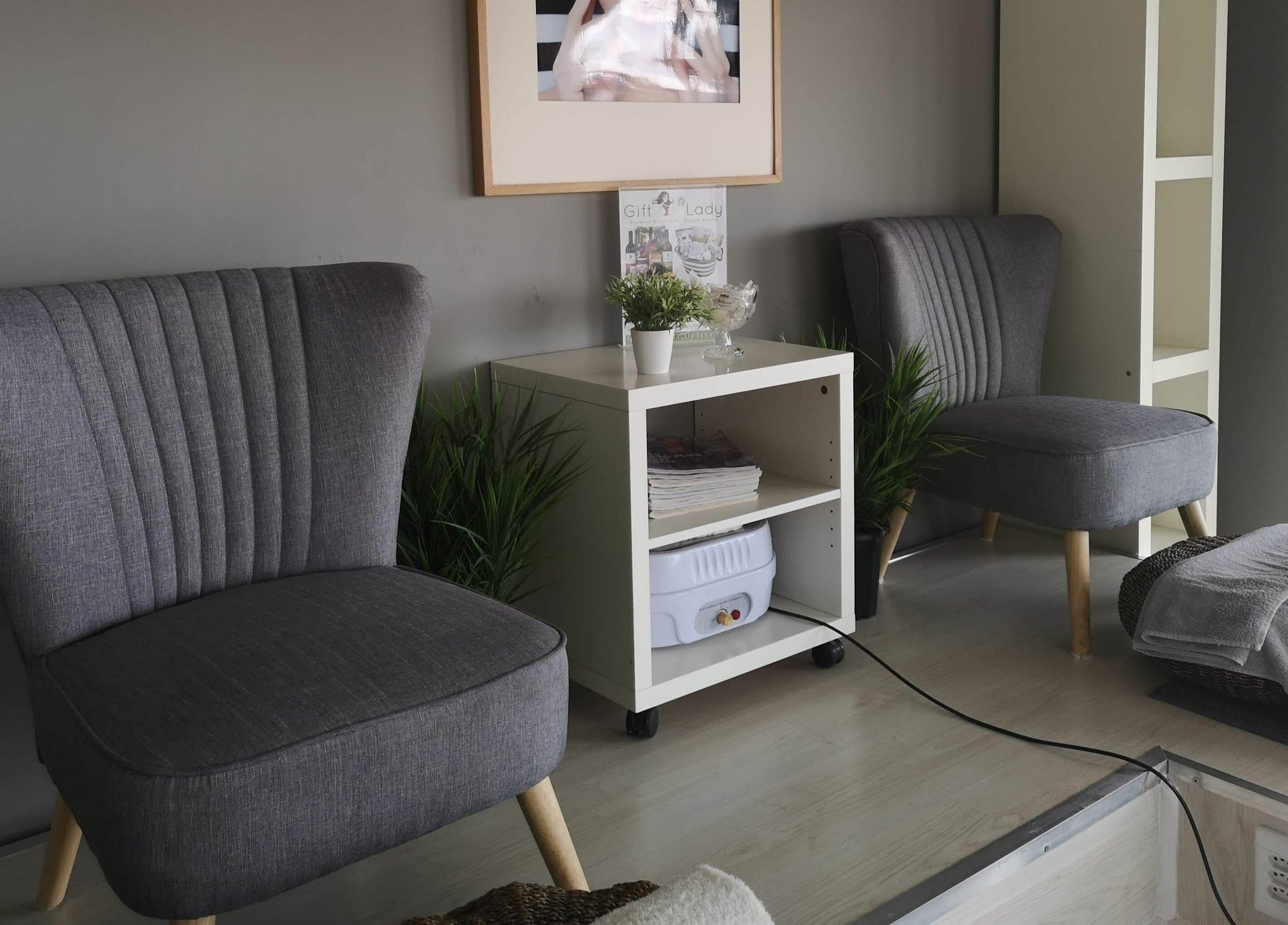 Relaxing lounge area at Beauty Bar, Port Elizabeth, Eastern Cape, ZA, featuring plush chairs and elegant decor.