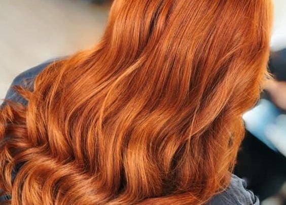 Lustrous copper hair waves styled at Expressions, Birmingham, England, GB salon.
