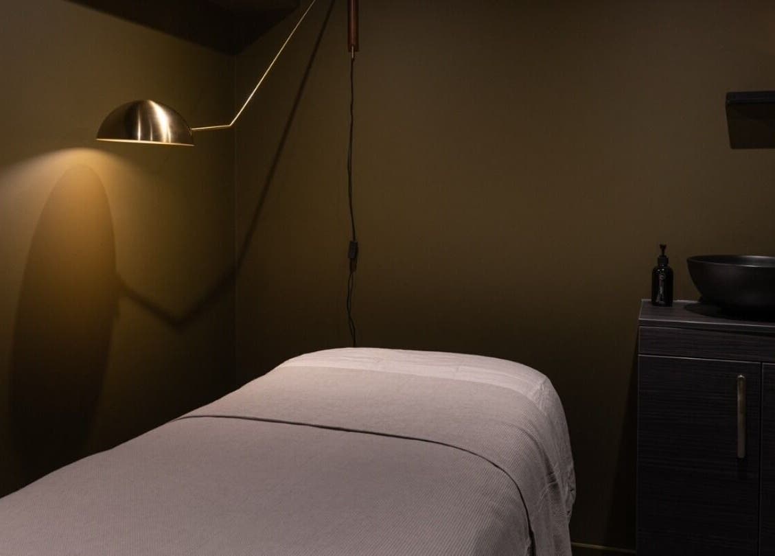 Tranquil treatment room at Still London in London, England, GB with warm lighting and modern decor.