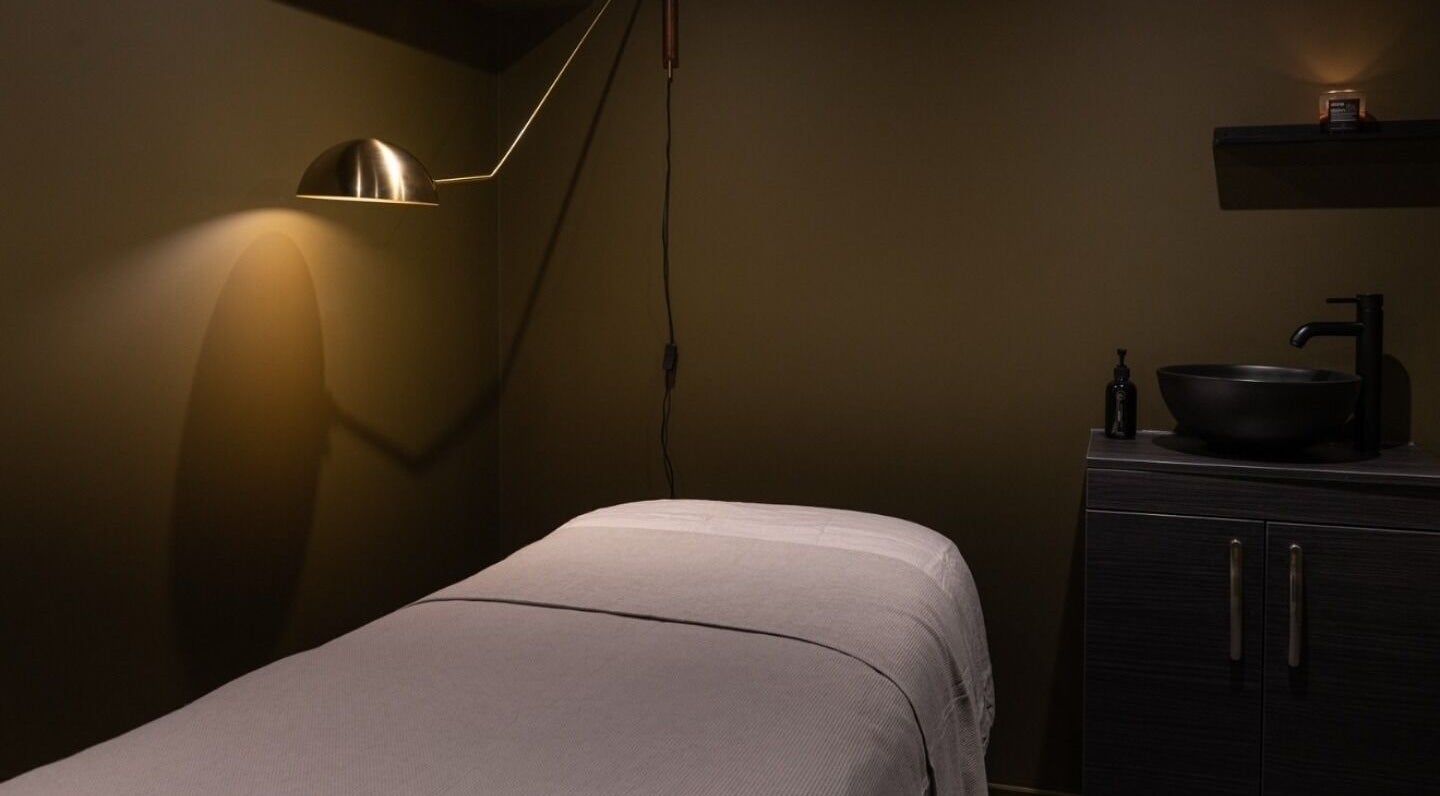 Tranquil treatment room at Still London in London, England, GB with warm lighting and modern decor.