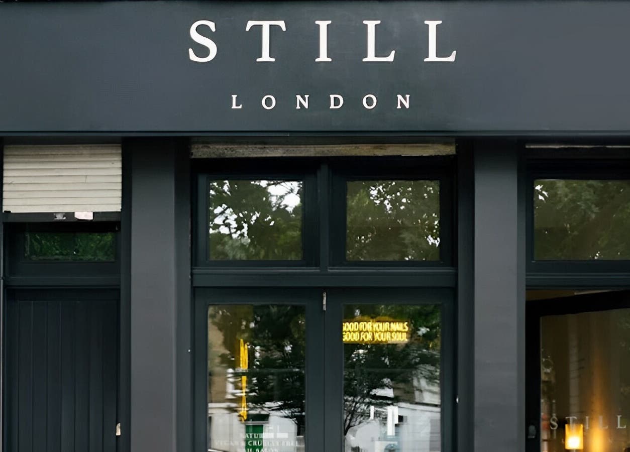 Entrance of Still London, a beauty and wellness venue in London, England, GB, with modern black facade.