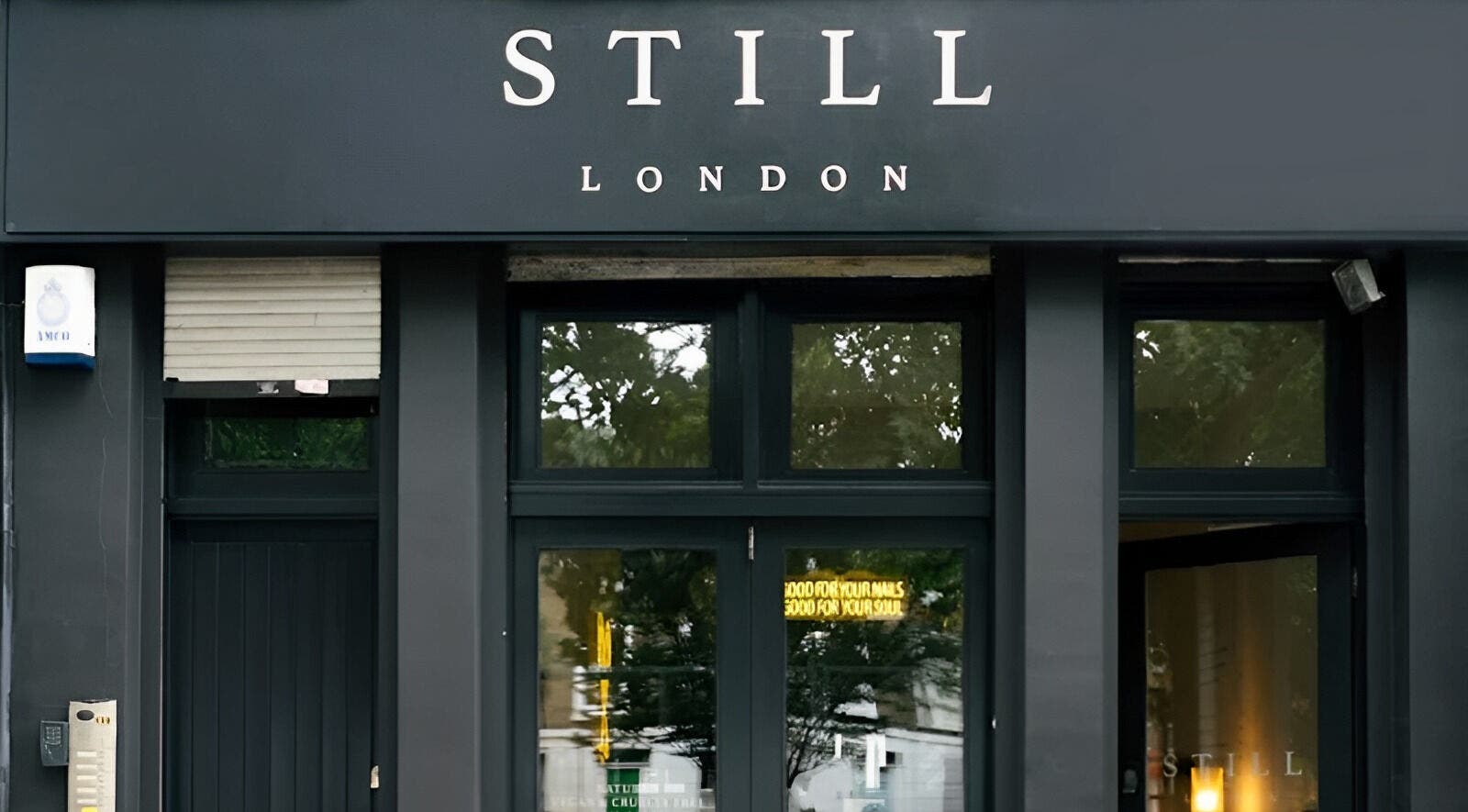 Entrance of Still London, a beauty and wellness venue in London, England, GB, with modern black facade.