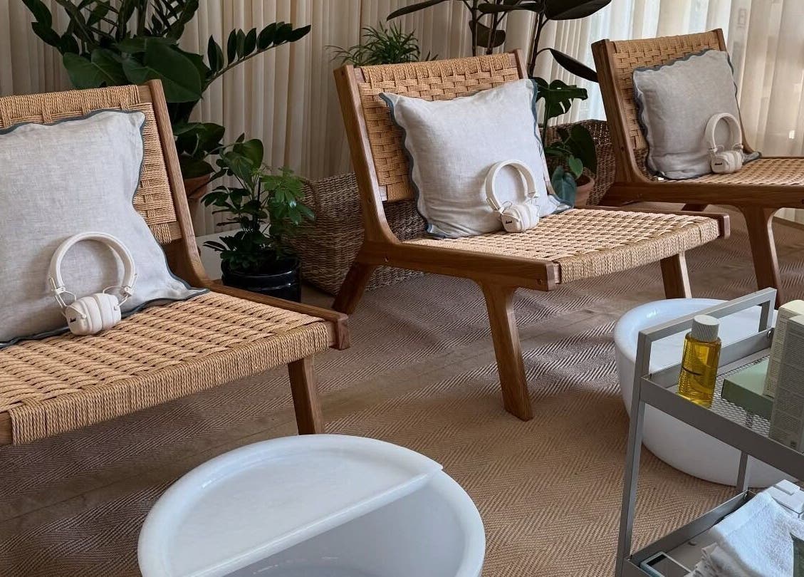 Relaxing spa chairs with cushions and headphones at Still London, London, England, GB, surrounded by plants.