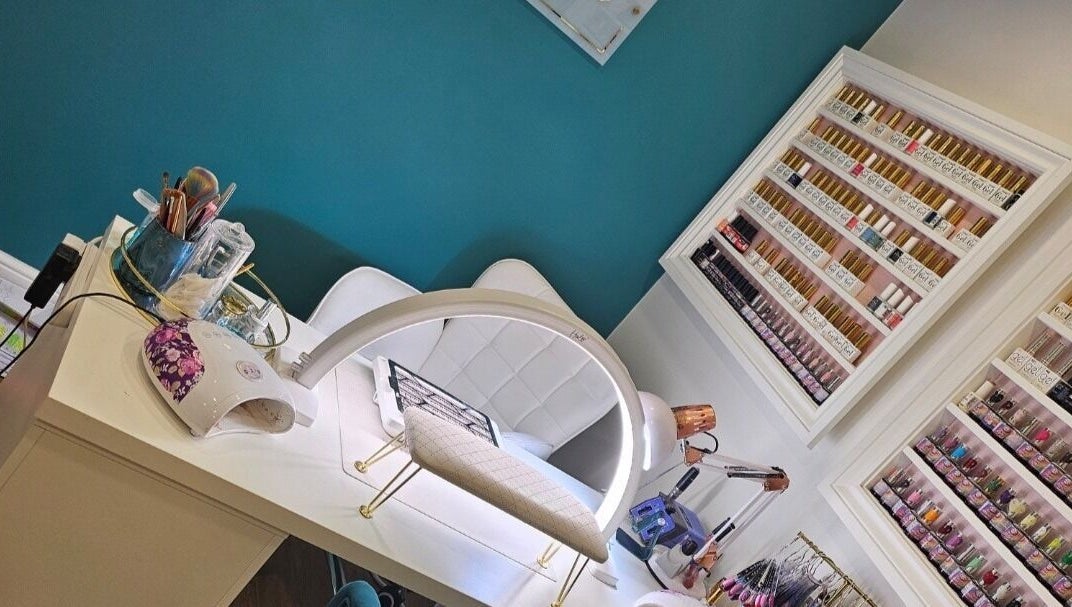 Perfect Touch Nail Bar in New Mills, England, GB features a modern design with a colorful polish display.