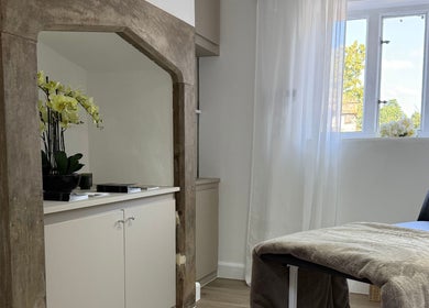 Elegant therapy room at Curlita Beauty & Skin Clinic, Stafford, England, GB with natural light and soft furnishings.