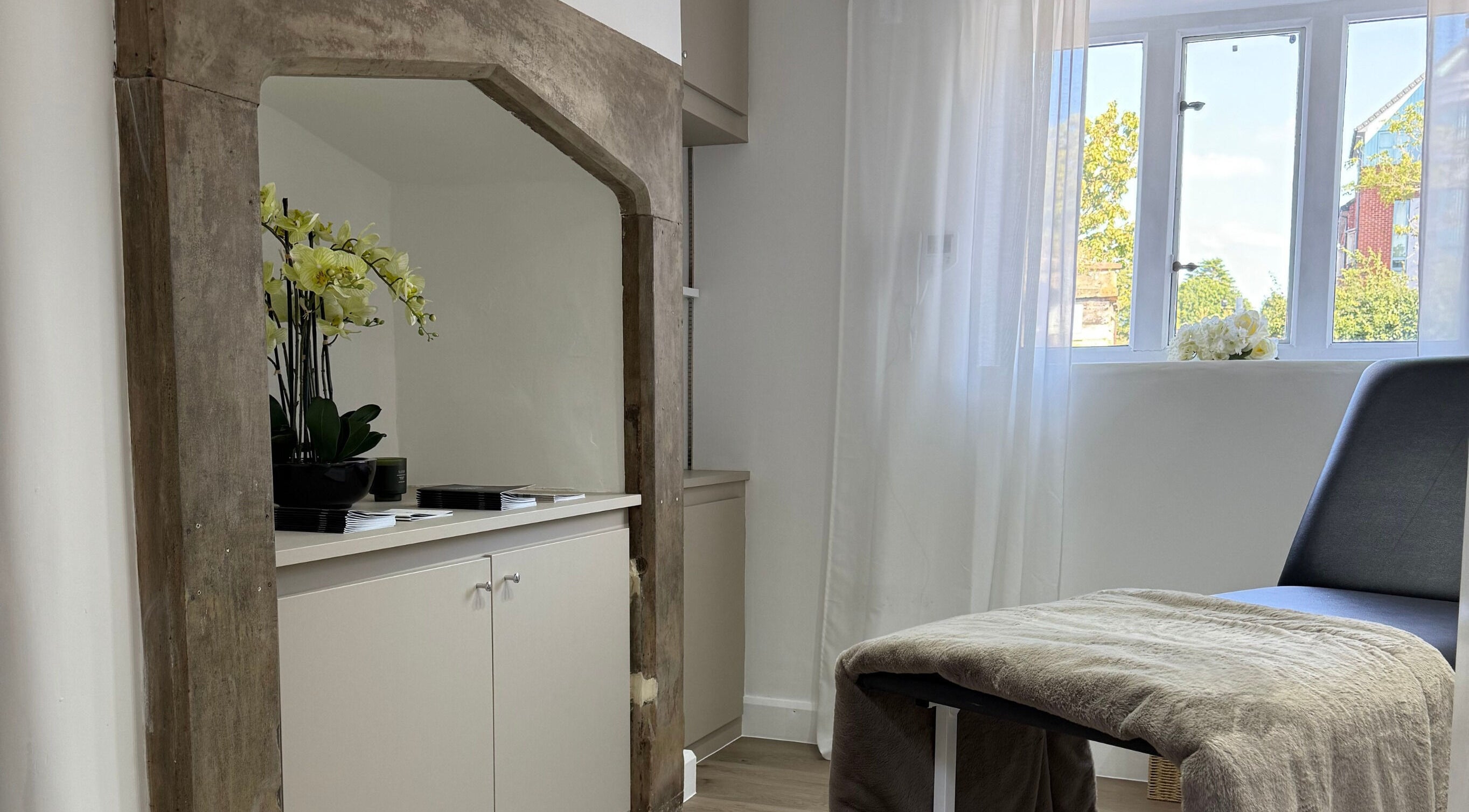 Elegant therapy room at Curlita Beauty & Skin Clinic, Stafford, England, GB with natural light and soft furnishings.
