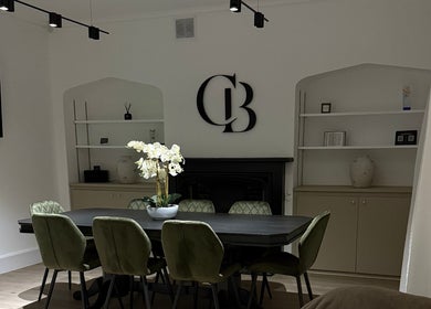 Chic meeting area at Curlita Beauty & Skin Clinic, Stafford, England, GB with green chairs and decor.