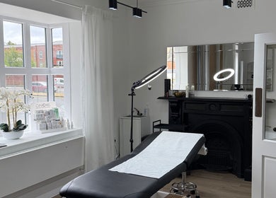 Modern treatment room at Curlita Beauty & Skin Clinic in Stafford, England, GB with a massage bed and elegant decor.