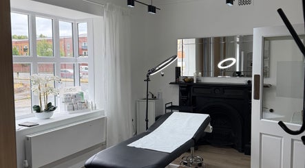 Modern treatment room at Curlita Beauty & Skin Clinic in Stafford, England, GB with a massage bed and elegant decor.