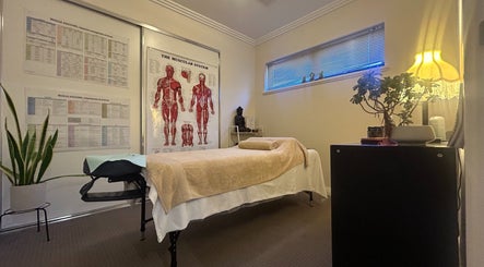 Serene therapy room at Move With Jase, Dianella, Western Australia, AU with massage table and anatomy charts.