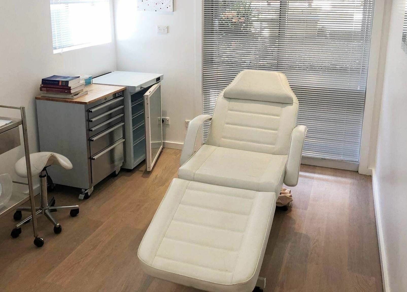 Modern treatment room at Shire Skin Renew, Miranda, New South Wales, AU, with reclining chair and medical decor.