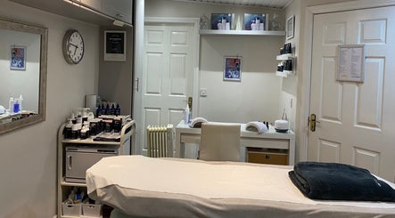 Serene treatment room at The Secret Beauty Company, Clane, Kildare, IE with skincare products and massage bed.