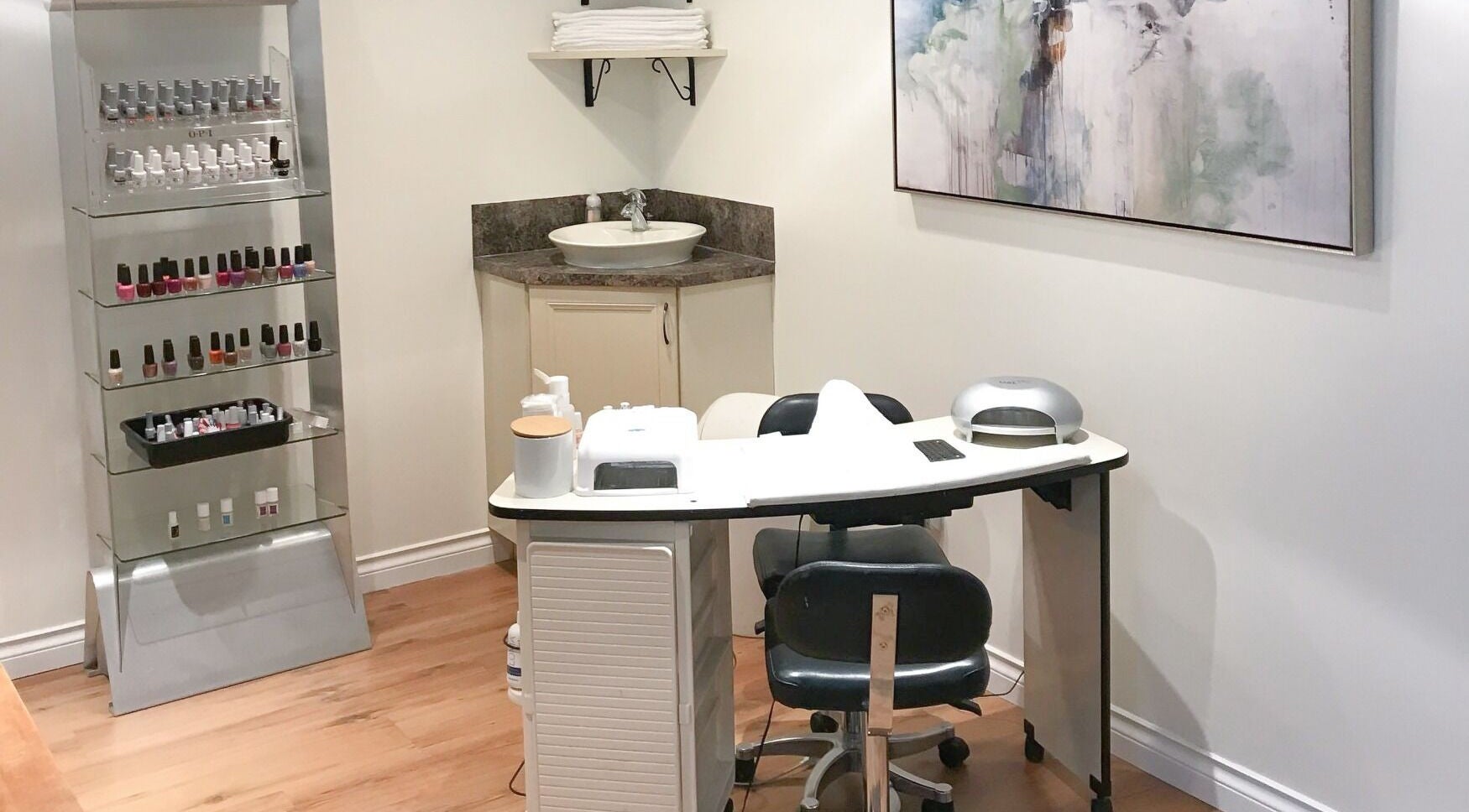 Nail salon station at Thairapy Salon and Esthetics Inc., Kelowna, British Columbia, CA, showcasing polish collection.