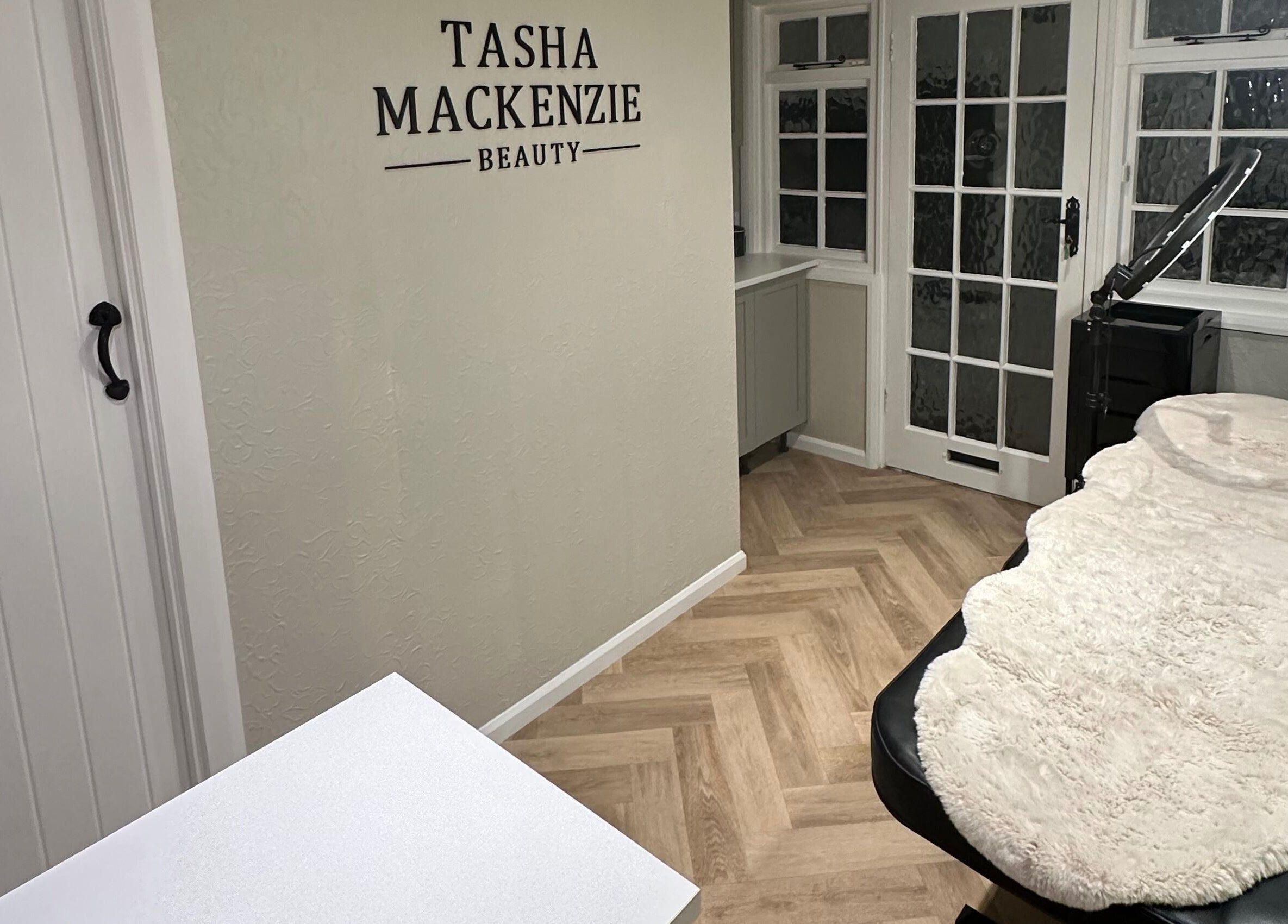Interior view of Tasha Mackenzie - BEAUTY's serene treatment room in Conwy, Wales, GB with elegant decor.