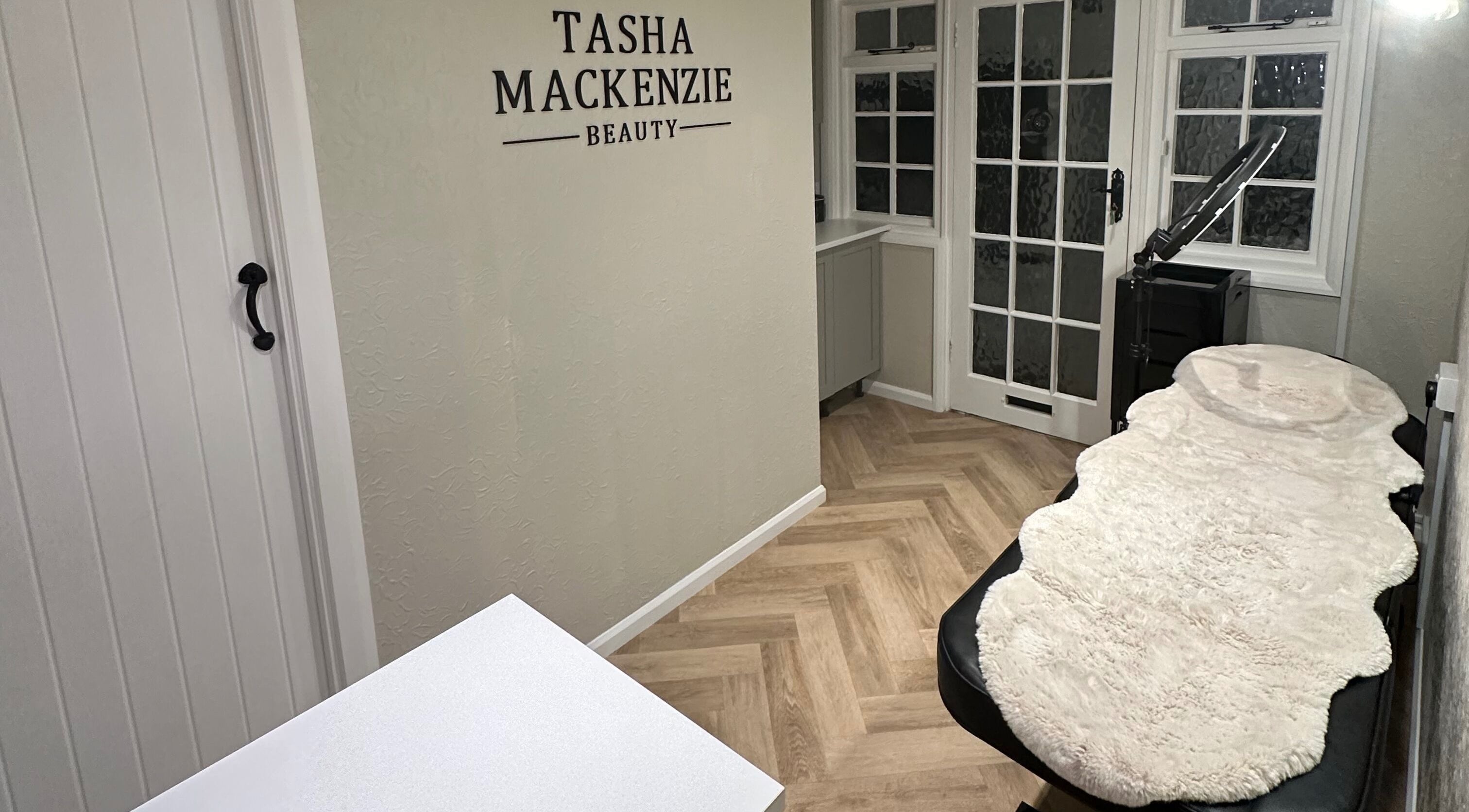 Interior view of Tasha Mackenzie - BEAUTY's serene treatment room in Conwy, Wales, GB with elegant decor.