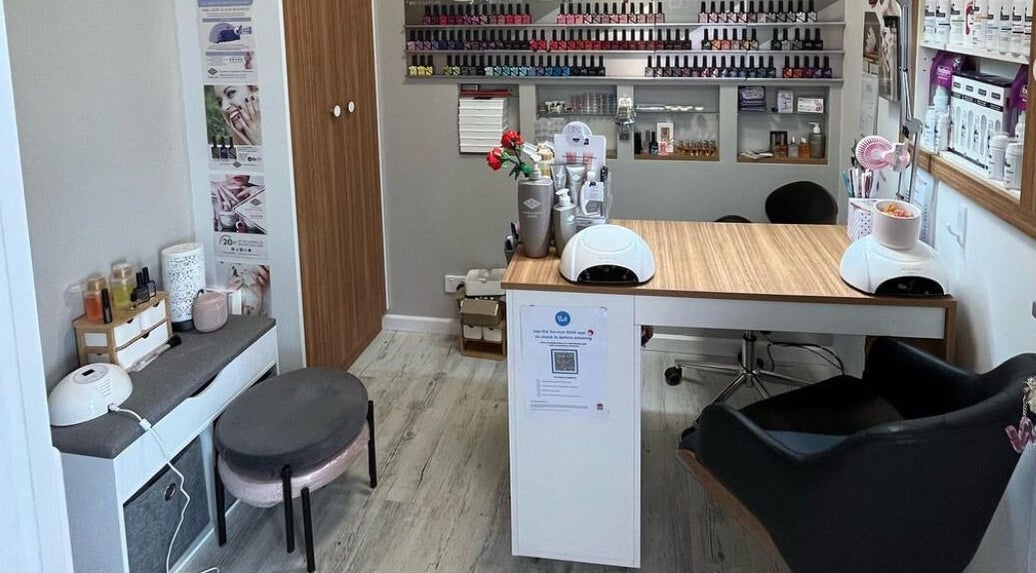 Modern nail salon setup at The Sculptured Nail, Palmwoods, Queensland, AU featuring vibrant polishes and seating.