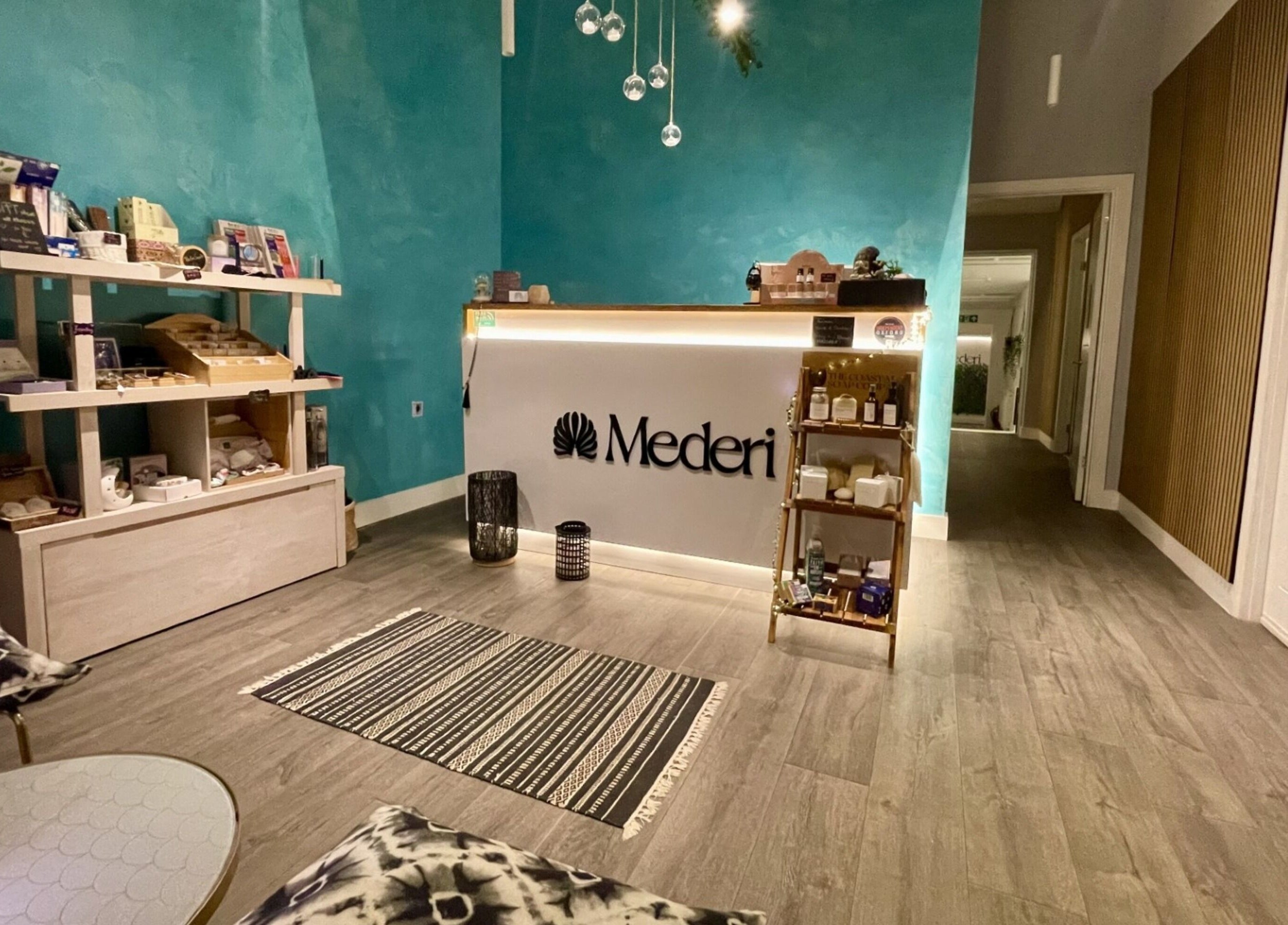 Mederi Wellness reception area in Garsington, England, GB, featuring a calming teal wall and serene decor.