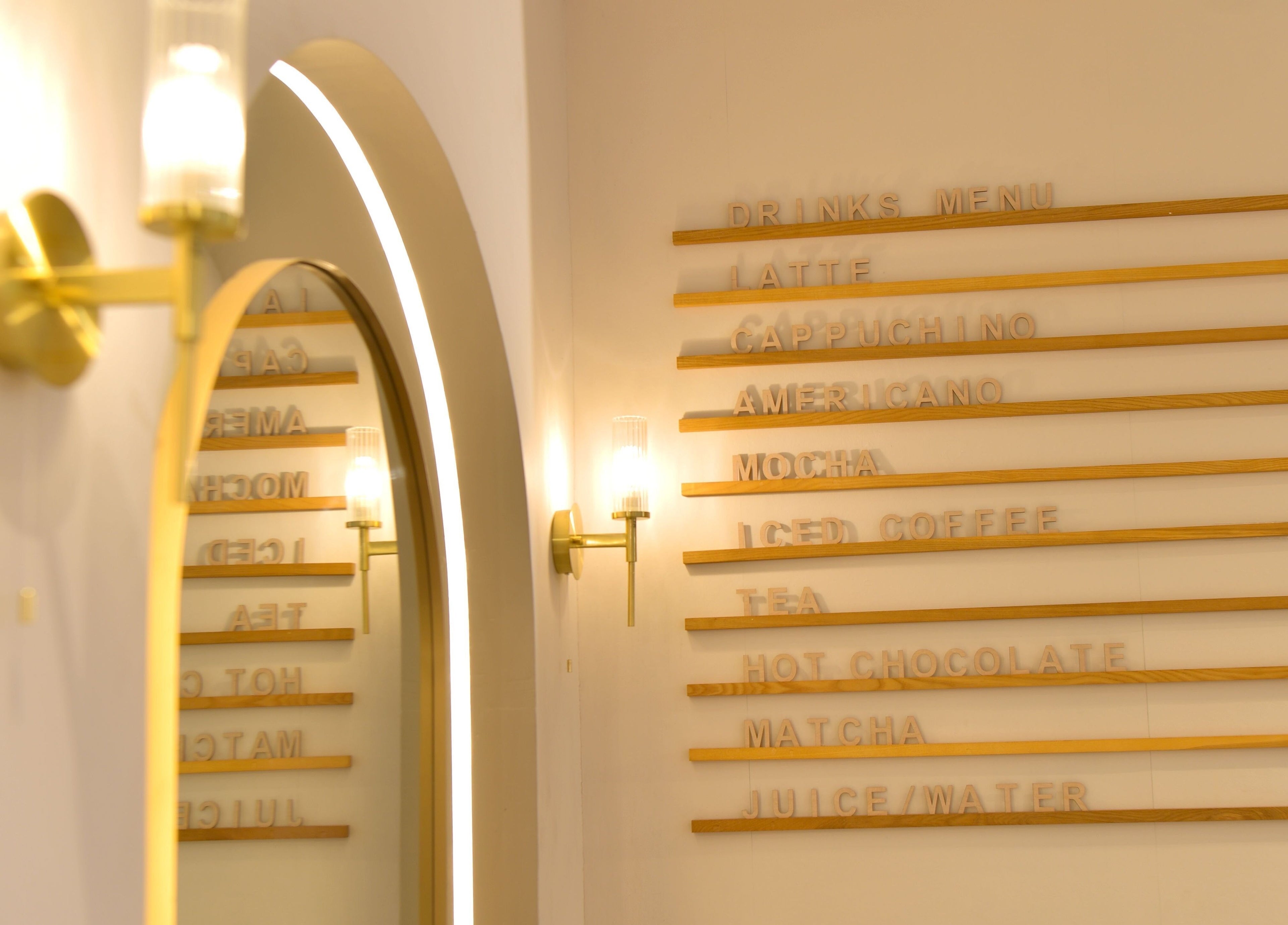 Reflected drinks menu at Blush 22 Hair and Beauty Lounge, Bradford, England, GB, showcasing modern elegance.