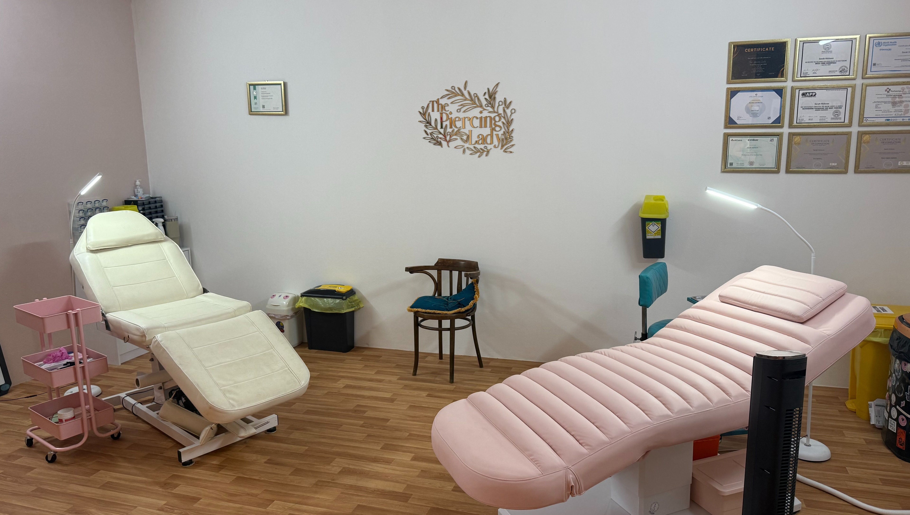 Modern treatment room at The Piercing Lady, Darlington, England, GB, featuring comfortable seating.