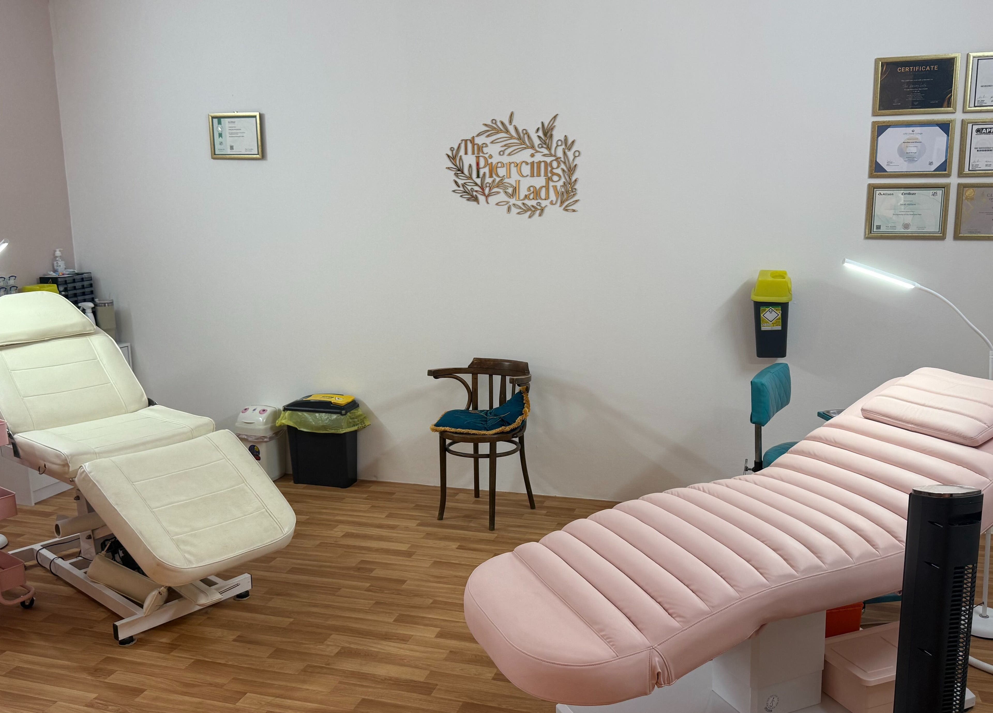 Modern treatment room at The Piercing Lady, Darlington, England, GB, featuring comfortable seating.