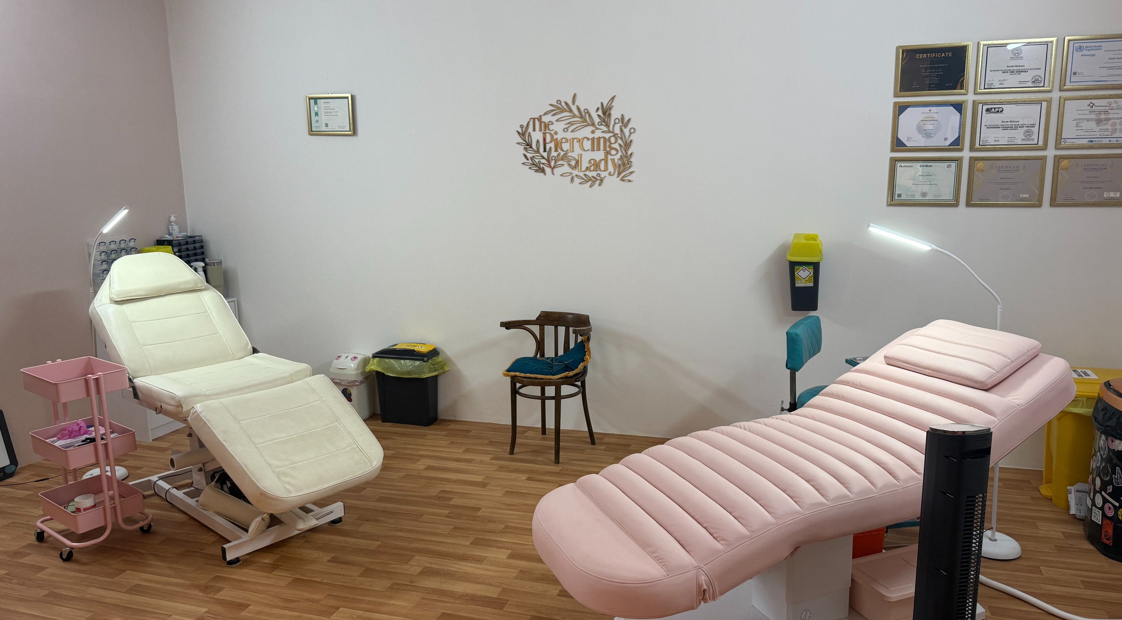 Modern treatment room at The Piercing Lady, Darlington, England, GB, featuring comfortable seating.