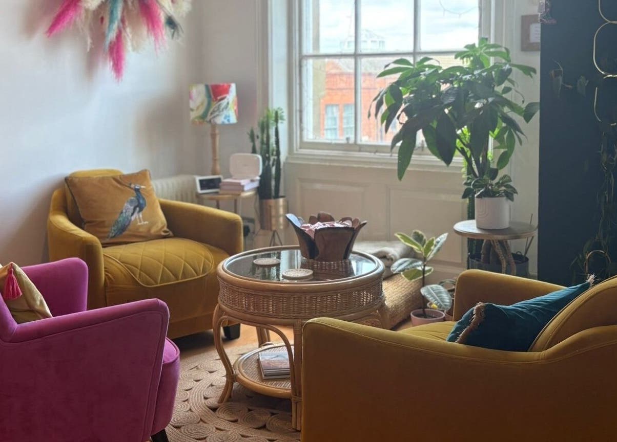 Inviting seating area at The Piercing Lady, Darlington, England, GB, featuring vibrant chairs and lush plants.
