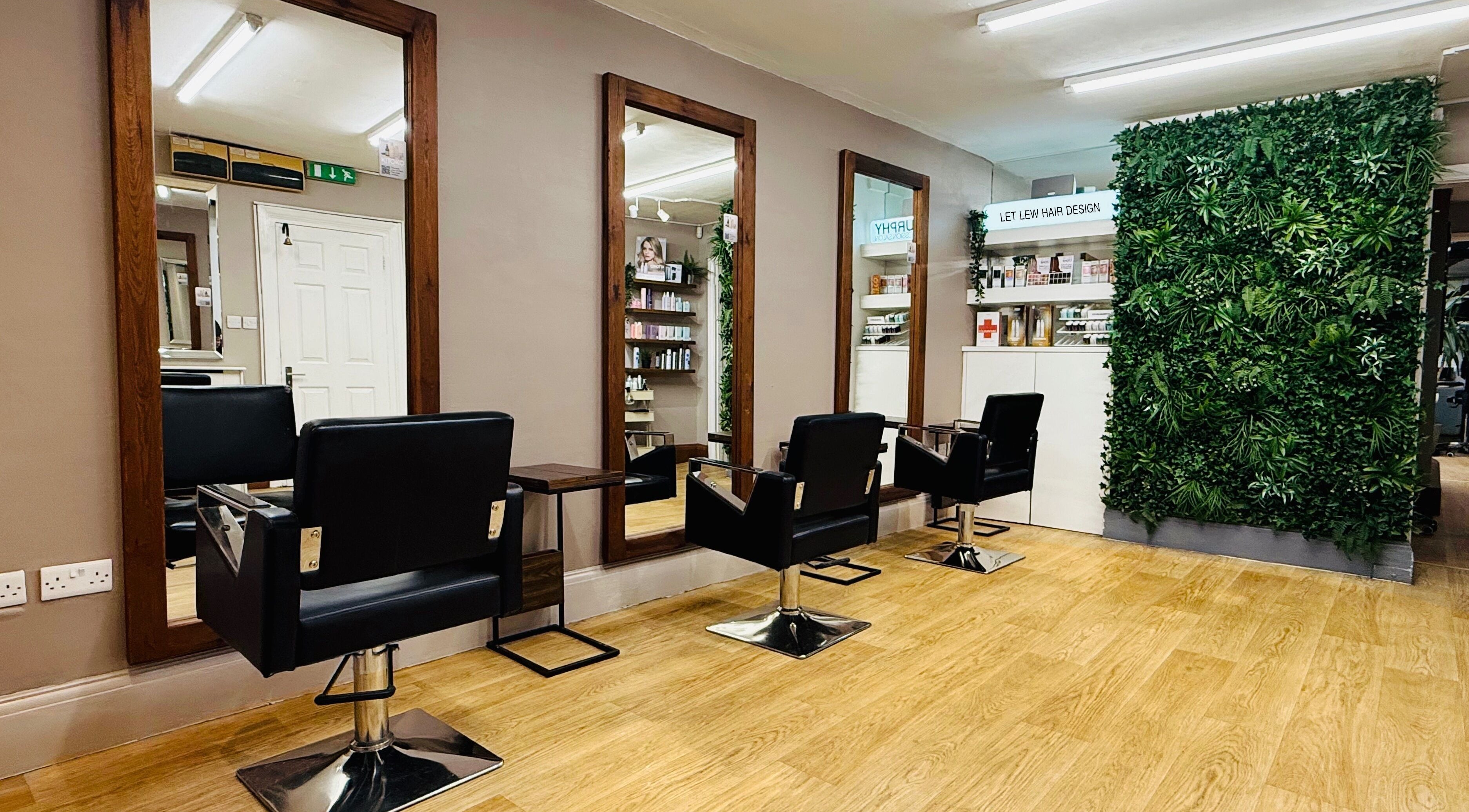 Stylish salon interior with black chairs at Let Lew Hair Design - Evesham, Evesham, England, GB.