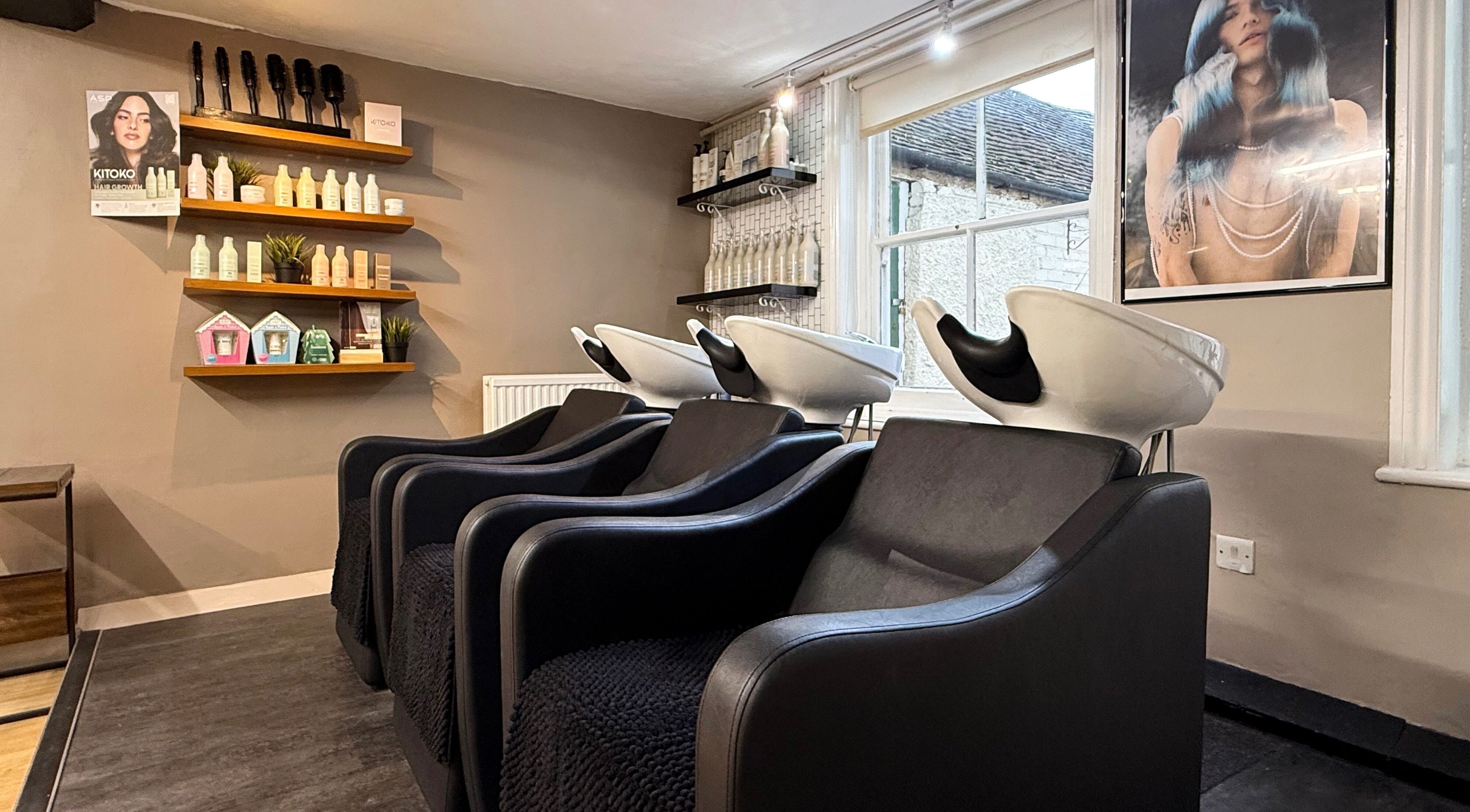 Modern salon wash station at Let Lew Hair Design - Evesham, Evesham, England, GB, showcasing sleek chairs.
