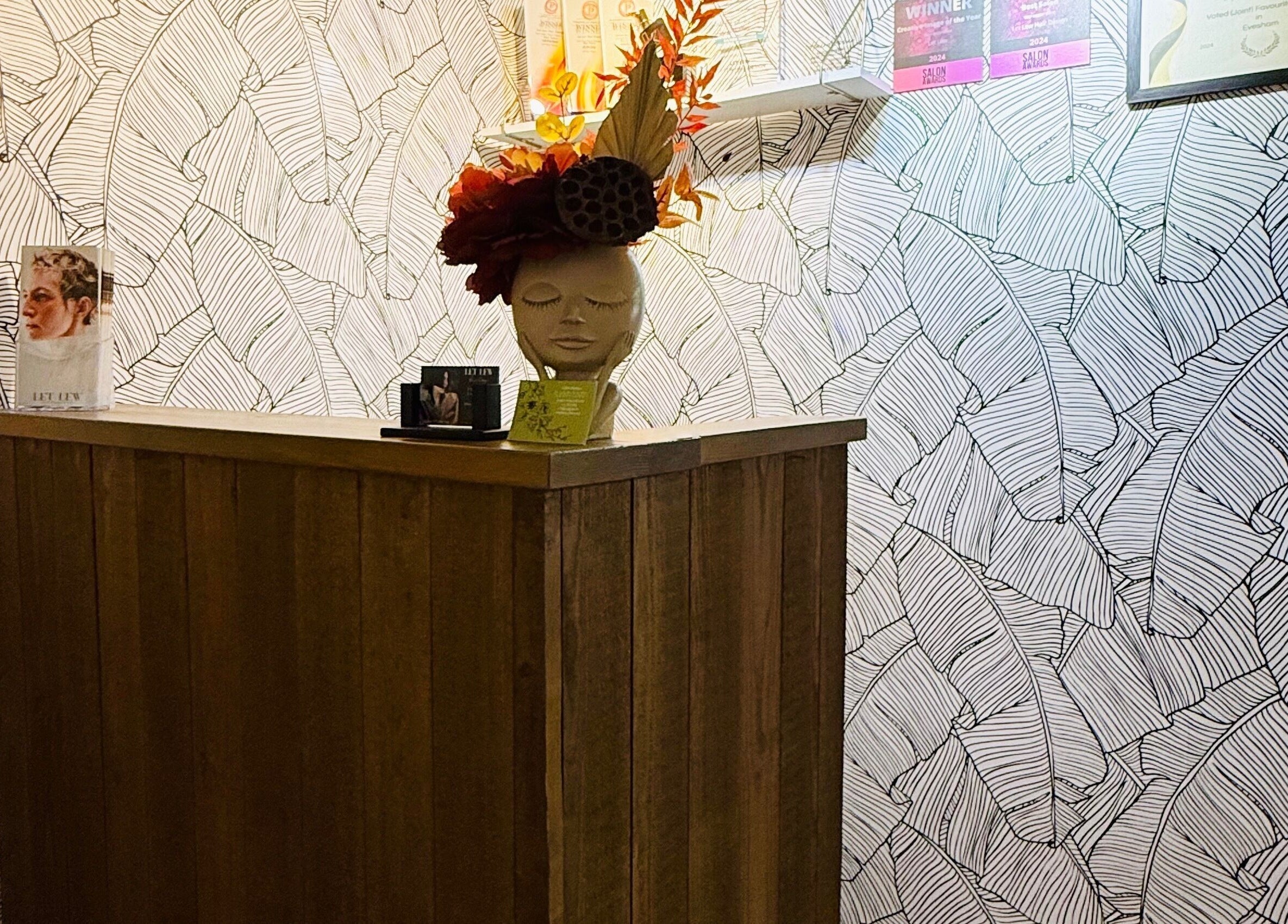 Reception area at Let Lew Hair Design - Evesham featuring artistic wallpaper in Evesham, England, GB.