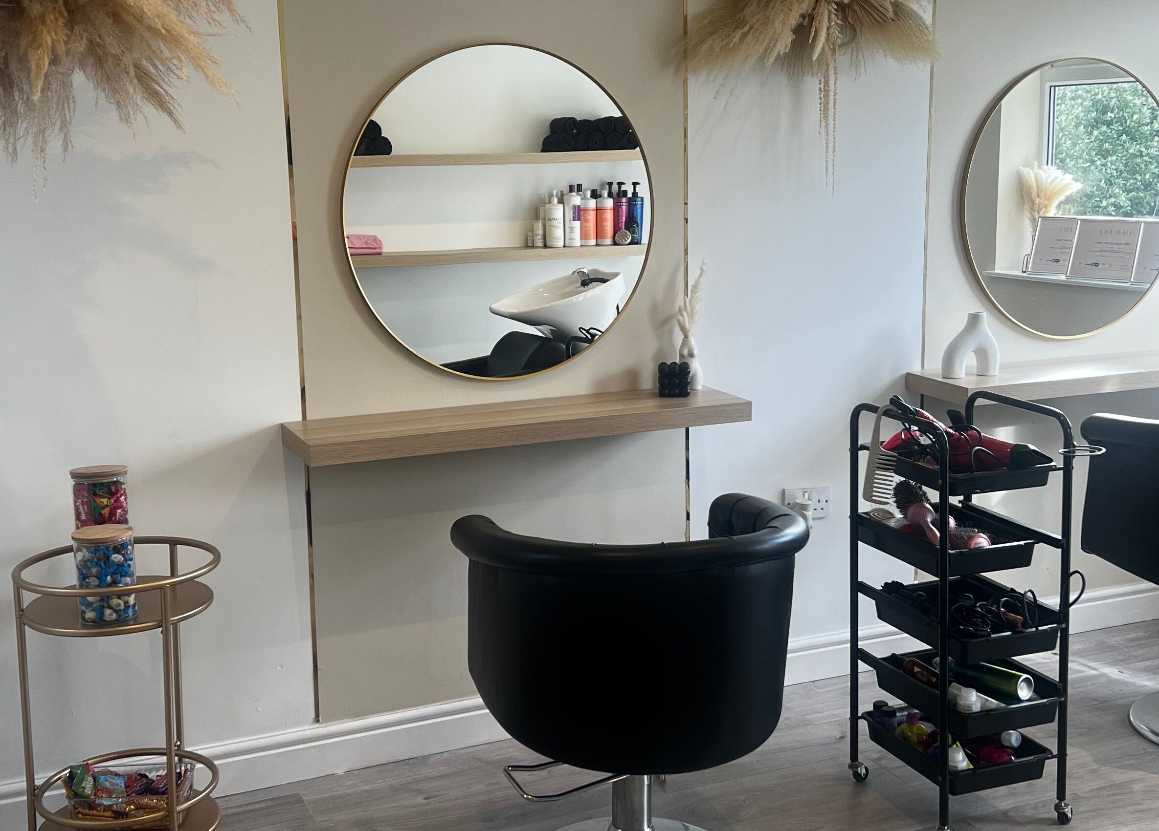Stylish salon setup at Studio Glow, Huddersfield, England, GB with mirrors and beauty products on display.